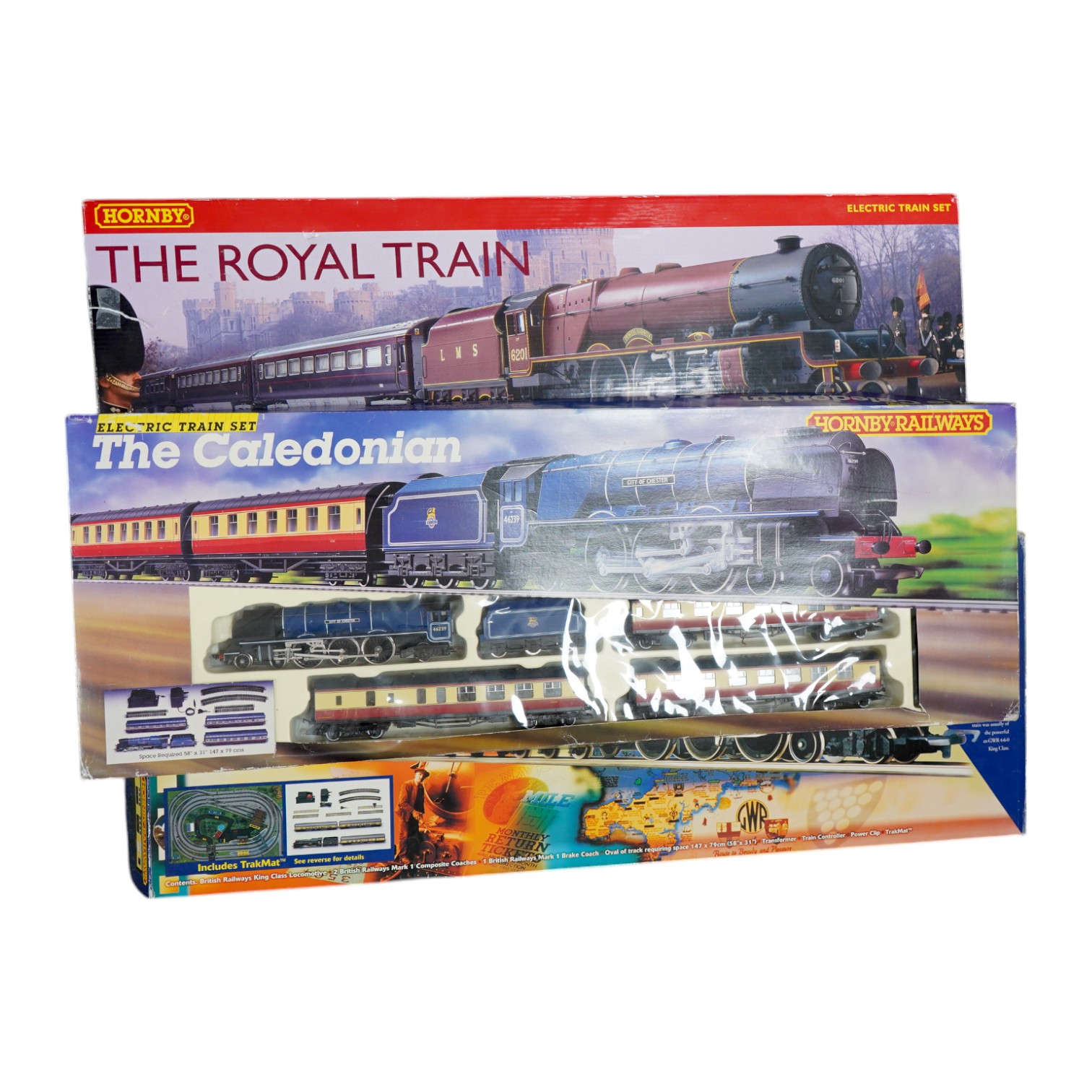 Three Hornby 00 gauge railway boxed train sets; The Royal Train (R1057), the Cornish Riviera Express (R826) and The Caledonian (R775), each comprising of a tender locomotive, three coaches, track sections, controllers, e